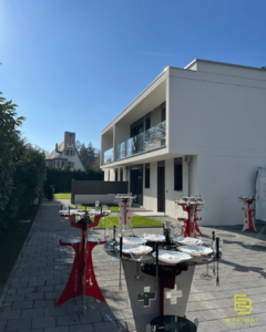 As seen from the driveway, the two new homes are aesthetically pleasing, with white geometric walls outlining the living spaces and surrounded by green hedgerows.