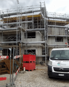 An exterior view of the new lodgings at Jussy. Looking at a cement facade.