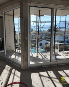 A view of the sun shining in through opening where windows will soon be installed