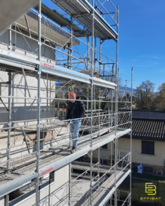 Sylvain walks the exterior of the newly erected building