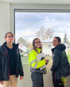 Elorri, Etienne et Marie-Laure in front of a window looking outside