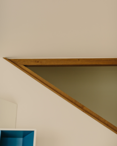 An angle of wood and glass mark the staircase going to the second floor