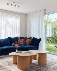 a view of the home's living space with a blue couch nestled in a corner