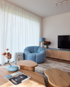 a pastel blue chair ties in the blues from the kitchen