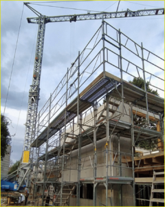 Scaffolding surrounds the exterior of a home